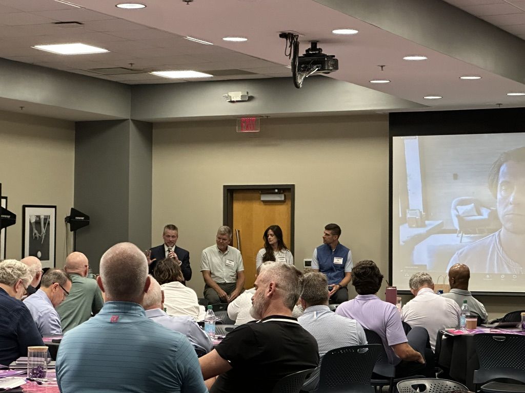 A panel discussion on AI adoption in front of a room of business professionals