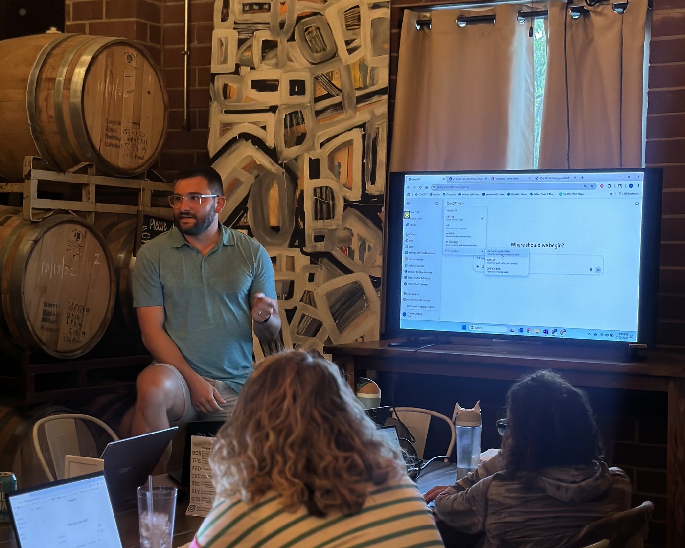 Clustr trainer walking a small group through ChatGPT model selection on a shared screen