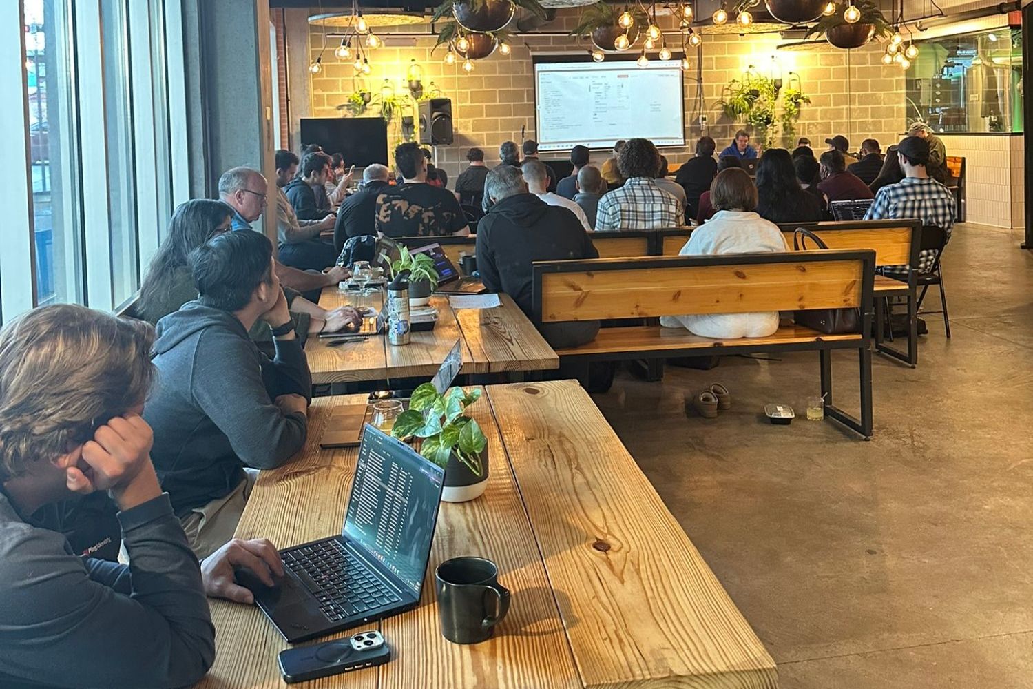 Professionals with laptops open during a hands-on AI build session
