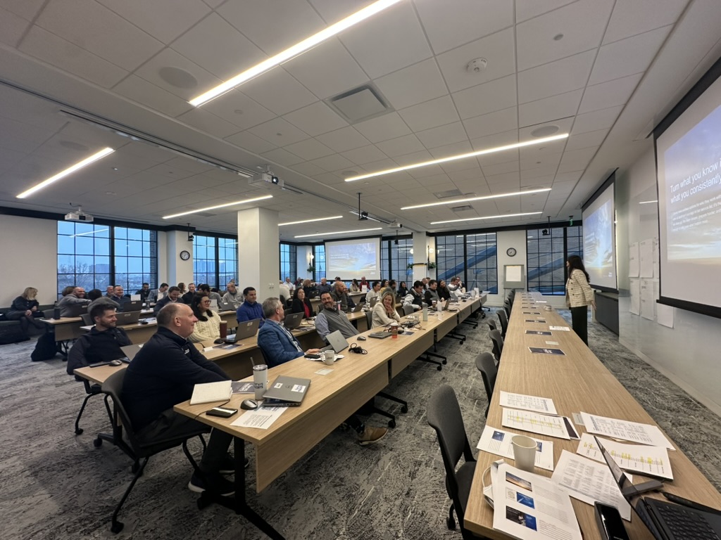 A Clustr partner leading a leadership AI enablement session in a full classroom