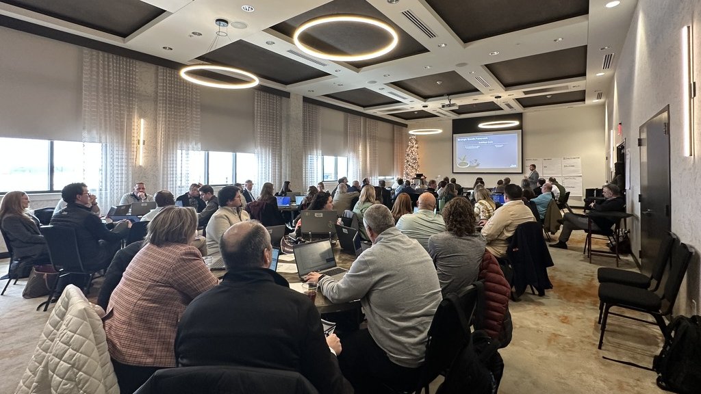 A full boardroom of employees in a live Clustr AI training session